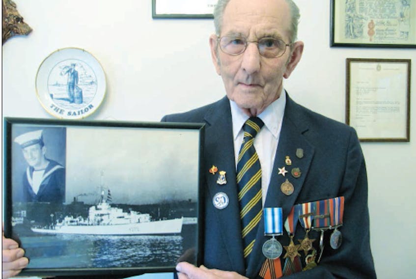 Ralph Patterson, pictured when he was 91, displays a photo of the HMCS Nene, a ship he served on as a leading torpedo operator in the Second World War. Tucked in the upper left corner of the picture frame is his portrait.