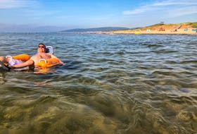 Kevin Penny, a C4 quadriplegic, soaks up some sun and surf with the help of a floating wheelchair.