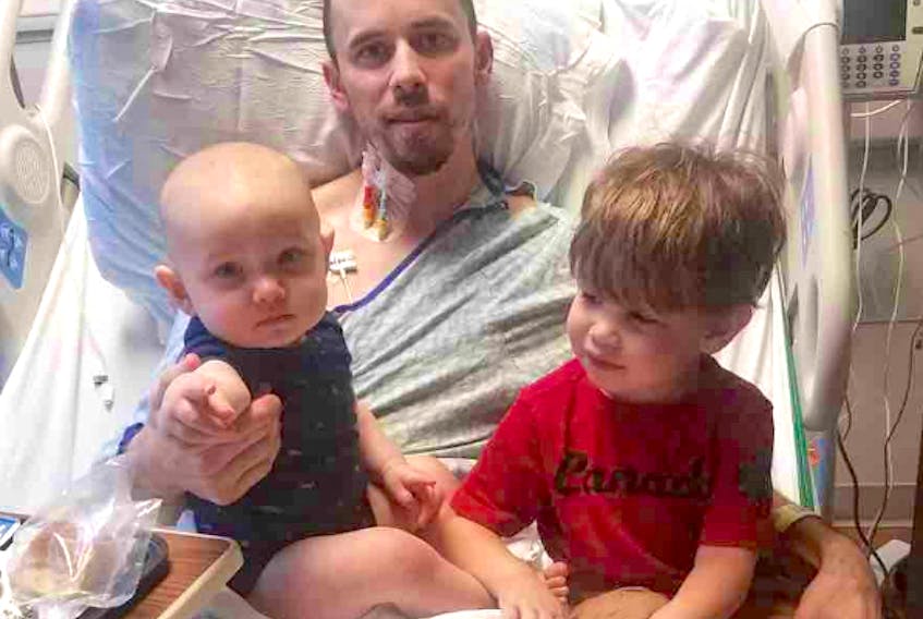 Warren Stafford with his two children in hospital in South Carolina. Mom Jessica is Jessica Steeves, originally from Wilmot. Stafford fell ill Sept. 21 and while things have improved, his recovery could take months.