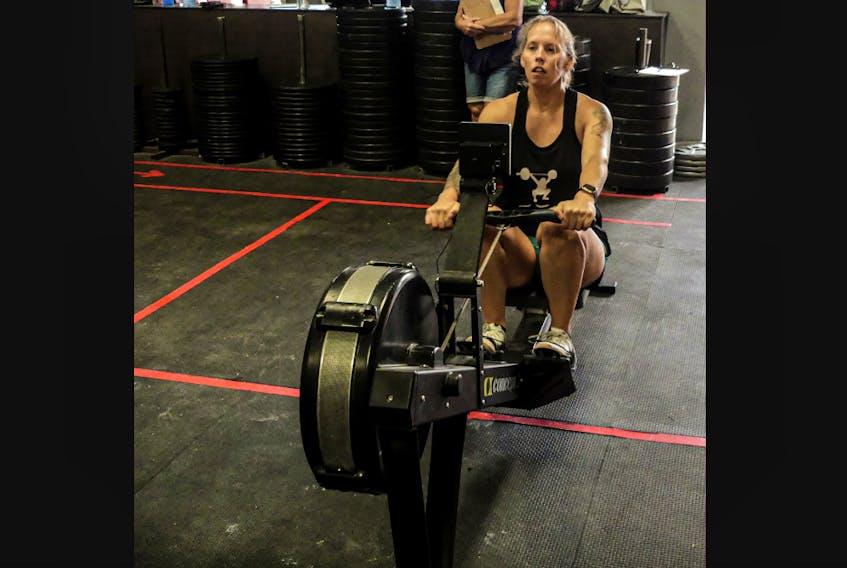 Jessica Davidson starts the drive portion of her stroke on a Concept2 rowing machine at Apple Valley CrossFit.