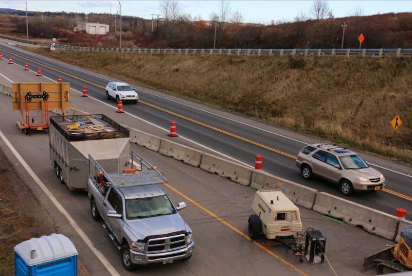 Motorists are shown being detoured on Highway 101 near Exit 6, downtown Windsor, as construction crews work underneath the overpass.
