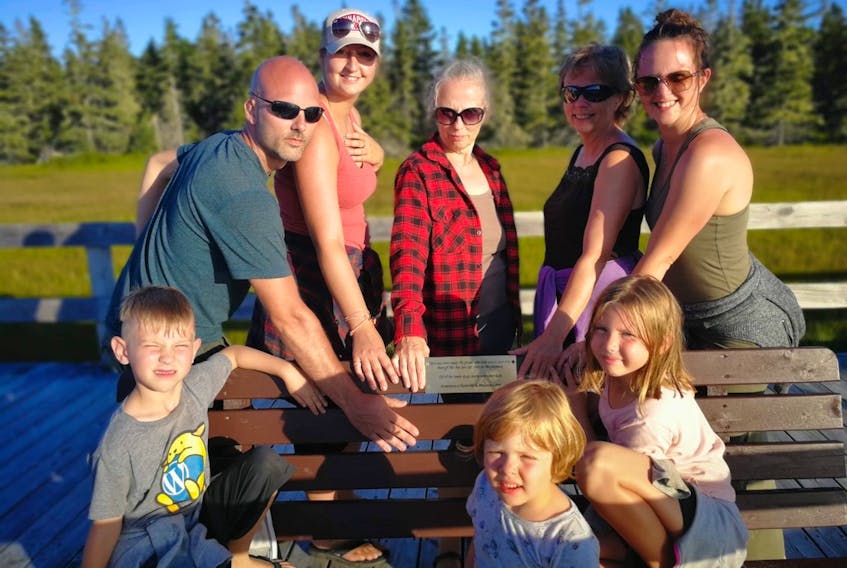 Three generations of Reynolds and Maureen Carty’s family – their daughters as well as three of their grandchildren and great-grandchildren – gather around the boardwalk bench placed at Rissers Beach in their honour. Mariann Card of Kentville is the fourth person, from left, in the back row.