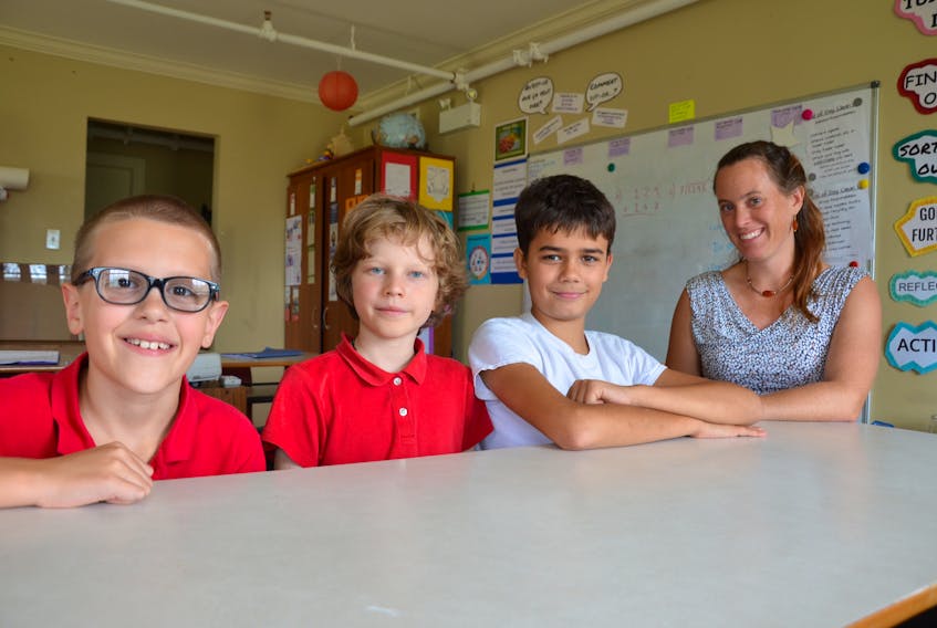 Temma Frecker, right, who teaches a Grade 5 and 6 class at The Booker School in Port Williams, decided to give her students her vote for the upcoming federal election. Along with their classmates, Jacob Townsend, left, Forest Lussing and Mason Testroete are taking the responsibility very seriously.