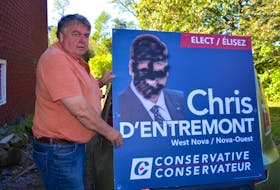 Wayne Atwater stands beside a vandalized Chris d’Entremont sign that was at the corner of School House Road and Highway 1 in Aylesford. Somebody ‘blackfaced’ the campaign sign for the West Nova Conservative candidate.