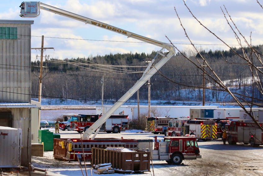 Three aerial trucks were positioned around CKF’s main industrial building as firefighters worked to contain and extinguish a fire that had started in a machine’s oven Dec. 12.