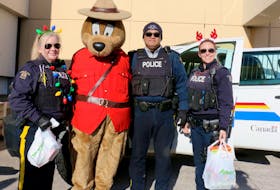 Officers with the Windsor District RCMP were out in force Dec. 7 – all for a good cause. From 10 a.m. until 2 p.m., the annual Stuff-a-Cruiser fundraiser was held to help support the local food bank. Pictured here are, from left, constable Heather Graves, Safety Bear (aka Dylan Balmaceda), Sgt. Mike Balmaceda, and constable Kate Sansom.
