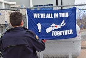 Const. Terry Garvin snaps a photo of a flag a local resident made for the Windsor West Hants RCMP detachment to show support following the devastating mass shooting in Nova Scotia.