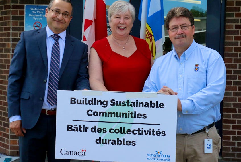 Abraham Zebian, the warden of the Municipality of the District of West Hants, stands beside Bernadette Jordan, the federal minister of Rural Economic Development, and Hants West MLA Chuck Porter, the provincial minister responsible for Municipal Affairs and Housing, following an infrastructure funding announcement July 18 in Hantsport.