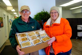 George Pickford and Heather Pickford, husband and daughter of Anne Anderson, hold tofu turkeys the family donated for the annual Christmas Day dinner hosted for the general public in Wolfville.