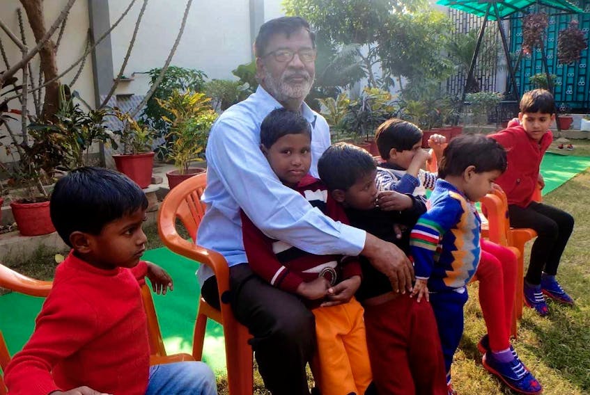 Father Abhi with some of the children he has rescued in India. A fundraising event will be held this week in Wolfville to help the project.