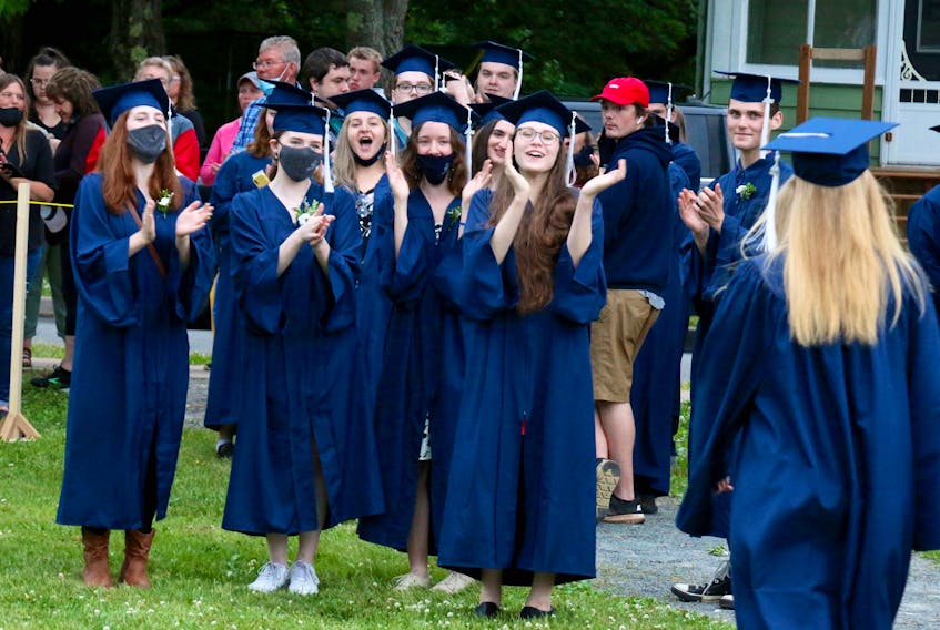 Classmates congratulate Laura George after graduating from Avon View. There was plenty of clapping and cheering at the non-school sanctioned ceremony June 28.