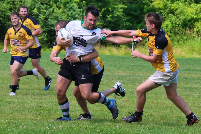 Valley Rugby Union players work in concert to try to take down a visiting PEI Mudmen player. The game between the Division 1 rugby teams took place in Windsor July 20.