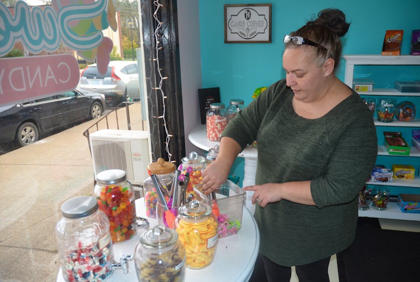 Amy Sertis gathers candy or an order at Sweeties Candy and Gifts in downtown Berwick. Orders and visits have been steady since the candy shop opened on Oct. 19.