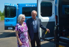 Seniors Minister Leo Glavine and Helen Juskow, chairperson of Kings Point to Point Transit, examine one of the two new vehicles purchased for the transportation company with a recent infusion of provincial money. Both were present at an announcement the provincial government made July 5 to provide funding to Kings Point to Point Transit and 17 other transit organizations.