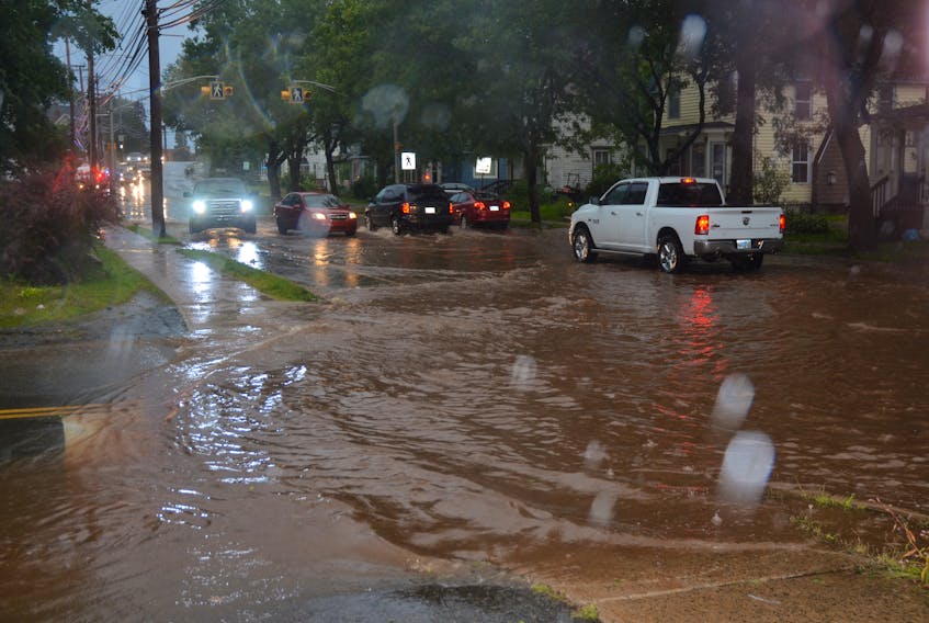 The intersection of Canaan Avenue and Main Street was inundated during high tide the evening of Sept. 7. Despite the waterlogged conditions, many forded the foreboding flood waters.
SAM MACDONALD