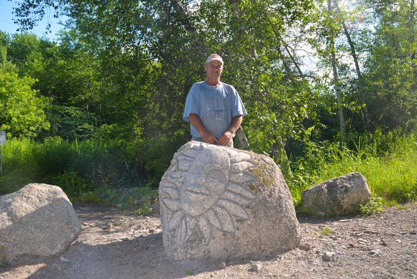 Brent Reeve, with one of his many carving creations in Berwick.