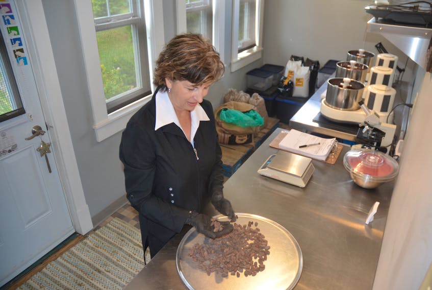 Gabrielle Breault sorts and prepares cocoa beans that will eventually become chocolate at the workshop for Petite Patrie, near Canning. Two types of chocolate from Petite Patrie won international-level bronze awards from the Academy of Chocolate.