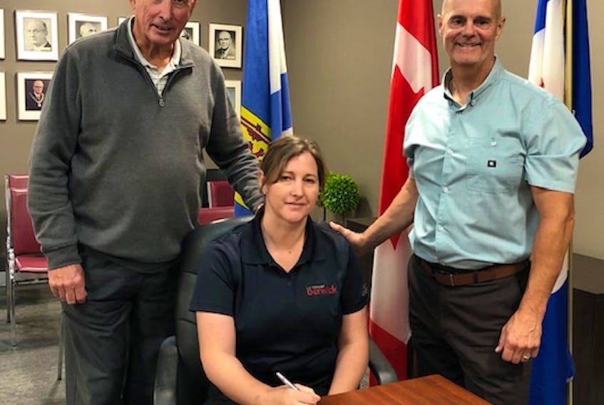 Ella Redden, the new bylaw enforcement officer for the Town of Berwick, signing her contract with Berwick Mayor Don Clarke (left) and CAO Michael Payne.