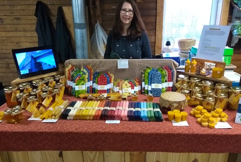 Jane Brandt, of Brandt’s Bees, shows some of the products they sell.