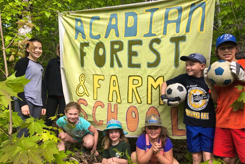 Sadie Bowen (left), Anna Chisholm, Norah Chisholm, Myra Chisholm, David Chisholm and Simon Chisholm were some of the young participants in a recent work party for the planned Acadian Forest and Farm School in Ohio, Antigonish County.