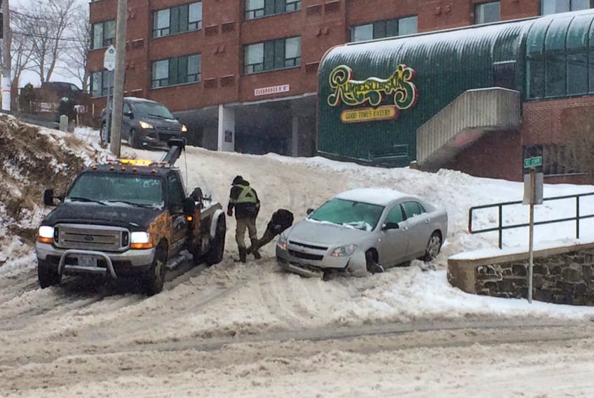 A vehicle is damaged after hitting a retaining wall near the Quality Hotel in downtown St. John's Tuesday morning as snow, ice pellets and freezing rain cause hazardous driving conditions.
