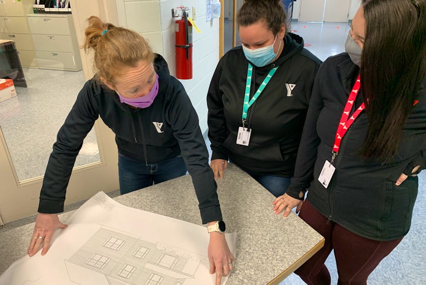(From left) Cumberland YMCA community development manager Alison Lair looks over plans for an affordable housing complex being prepared on the corner of Church and Wellington streets in Amherst with housing support worker Amanda Mollon and diversion support worker Ellen Gaudet.