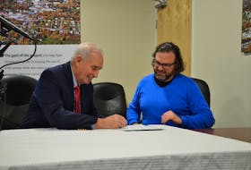 Berwick Mayor Don Clarke signs a renewable energy and energy storage agreement as Equilibrium Engineering operating partner Jeremy Lutes looks on. KIRK STARRATT
