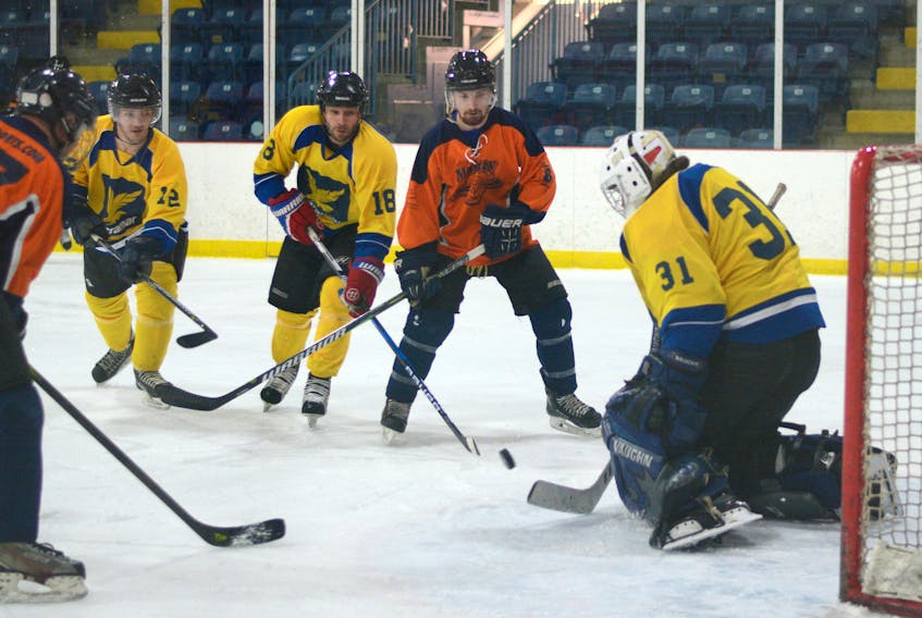 Jon Tattrie, centre, looks for a rebound off of Ultramar goaltender Michael Scott in the final AAHL game of the regular season at the Richard Calder Arena in Springhill. Tattrie had 12 points in the game.
