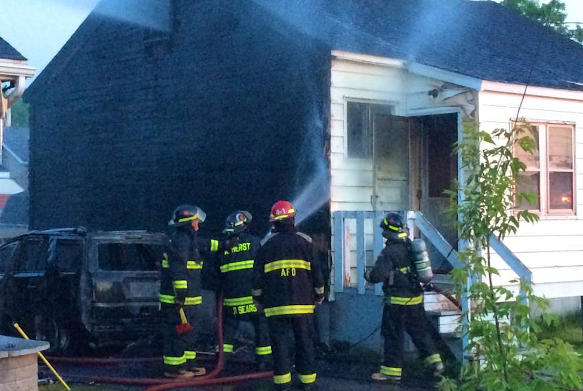 Amherst firefighters extinguish a fire at 8 Edgewood Ave. in Amherst on Monday night.