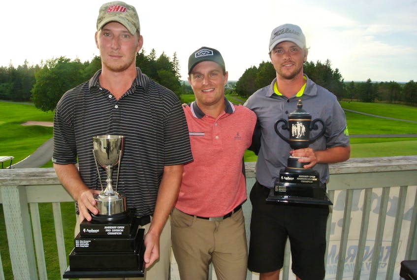 Amherst club professional Michael Archibald (centre) presents the Amherst Open pro trophy to Matt Shubley (left) while Brodie Ward accepts the amateur championship trophy.