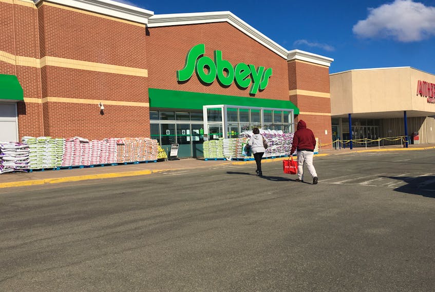 Two customers enter Sobeys in Amherst on Wednesday. Amherst Police have been running a focused enforcement program targeting out of province vehicles coming into the community to shop. Three people were charged on Monday for disobeying the Health Protection Act.