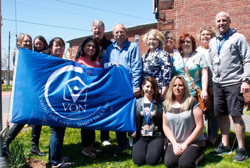 Amherst Coun. Vince Byrne, Mayor David Kogon and Deputy Mayor Sheila Christie are surrounded by VON workers and supporters moments before the VON flag was raised over the Town of Amherst on May 18. Pictured are Angela Stonehouse, Emily Stonehouse, Mona Teed, Marshella Power, Byrne, Kogon, Christie, Marsha Gallant, Alycia Gunn, Geoff Cormier, Kristy Boudreau and Amanda Oickle.