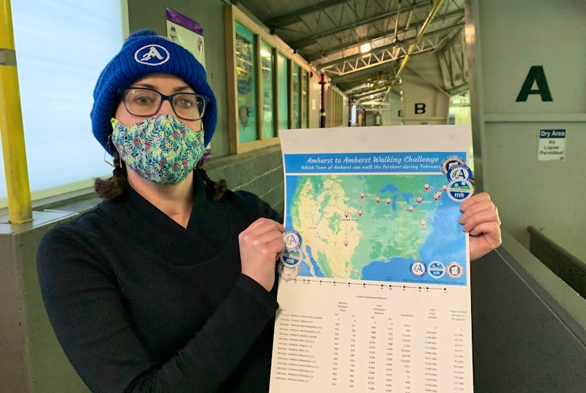 Amherst’s active living co-ordinator Allison Watson holds up a map of the Amherst to Amherst Walking Challenge that will see people in this community keep track of kilometres walked, biked or ran during February as part of a friendly competition with Amherst, N.Y and Amherst, N.H.