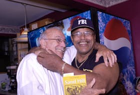 Rocky Johnson puts former Amherst mayor Jerry Hallee in a headlock during a book signing in Amherst in 2005. Johnson came to Amherst to support the release of Darlene Strong’s book, Sand Hill. Contributed