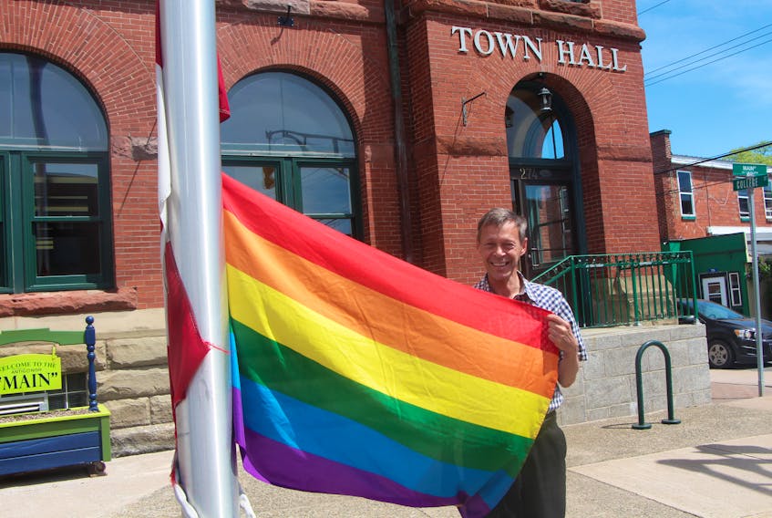 Town of Antigonish councillor Andrew Murray is pictured with the Pride Flag which is currently hung on the town hall flag pole on Main Street, and will be up for the month. As an openly gay man, Murray talked about the significance.