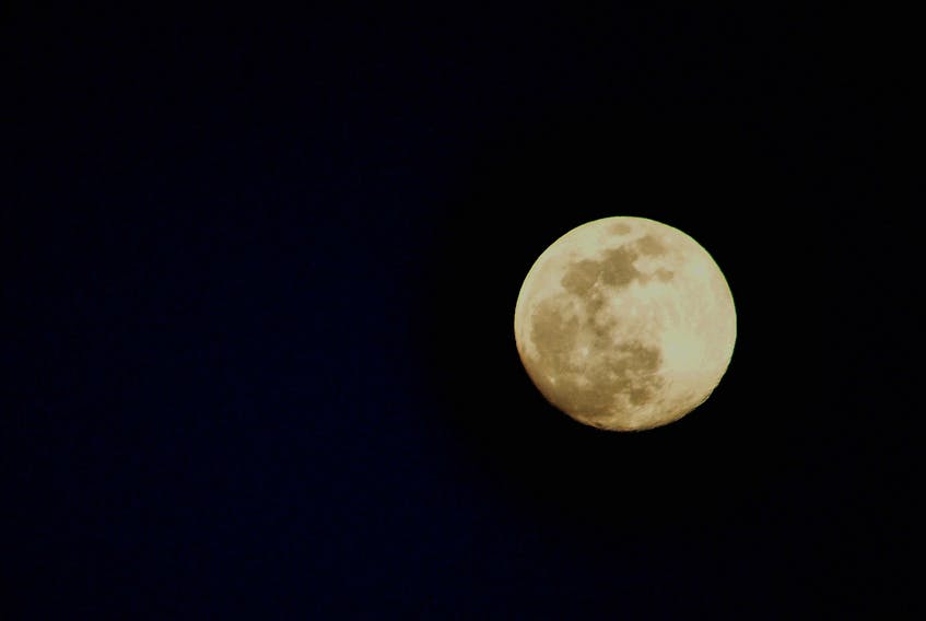 A full moon can look very full the day before and the day after its official full phase is reached.  Dennis Curran was under a mostly clear sky in Lunenburg country NS on Monday night.  He is sharing this superb photo with those of us who might have missed this year’s supermoon, also known as the Full Pink Moon.