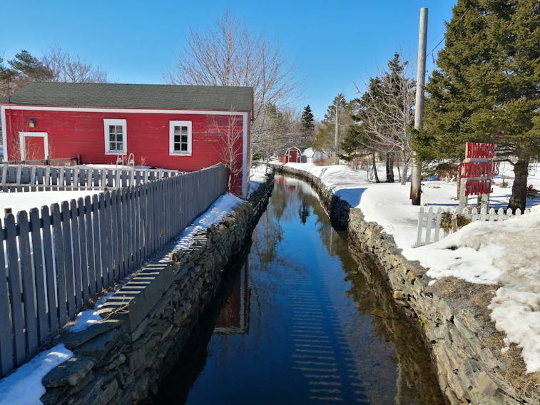 While some Atlantic Canadians are cleaning their flower beds, others will have to wait a while before they start any garden work.  Gary Mitchell came across this charming "wintery scene" at Wilcox Gardens in Brigus N.L. The icy water that flows between the flagstone walled canal, is very still on this lovely blue-sky April day.