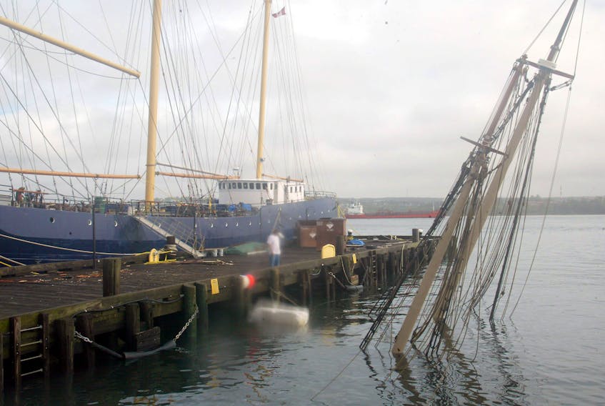 The masts of a sunken boat stick out of Halifax Harbour after it sank in Hurricane Juan on Sept. 29, 2003.