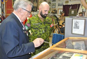 Ray Coulson, curator of the North Nova Scotia Highlanders Regimental Museum, gives Major Jean Francois Robert, the G4 with the 36th Canadian Brigade, a tour of the museum on Dec. 3.