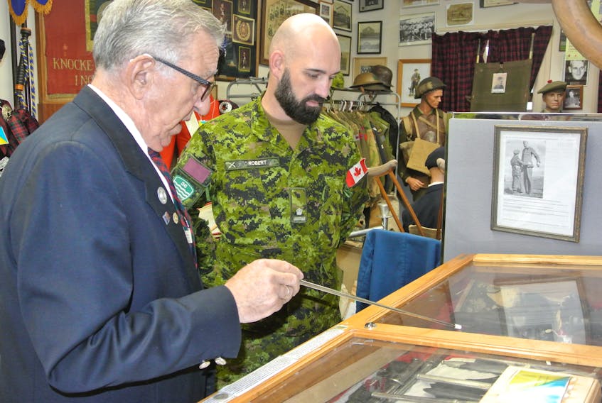 Ray Coulson, curator of the North Nova Scotia Highlanders Regimental Museum, gives Major Jean Francois Robert, the G4 with the 36th Canadian Brigade, a tour of the museum on Dec. 3.