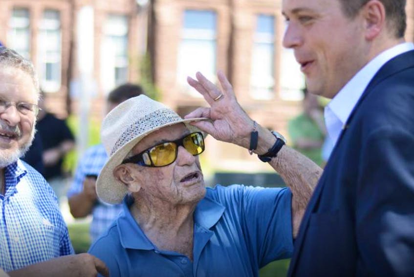 Andrew Scheer (right), shown with former Nova Scotia Premier Roger Bacon during a visit to Amherst in August 2018, announced Thursday he is stepping down as leader of the Conservative Party of Canada. File