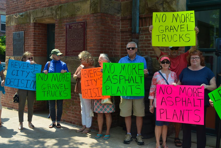 Protesters gathered in front of City Hall in Charlottetown at lunch time to fight council's recent decision to amend the zoning and development bylaw that will allow for more concrete and asphalt plants on Sherwood Road.