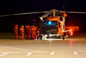 Crew members from the Atlantic Destiny arrive, via a U.S. Coast Guard helicopter, at the Yarmouth Airport around 3 a.m. on Wednesday, March 3 after the fishing vessel experienced a fire, lost power and took on water while on a fishing trip on Georges Bank. TINA COMEAU PHOTO