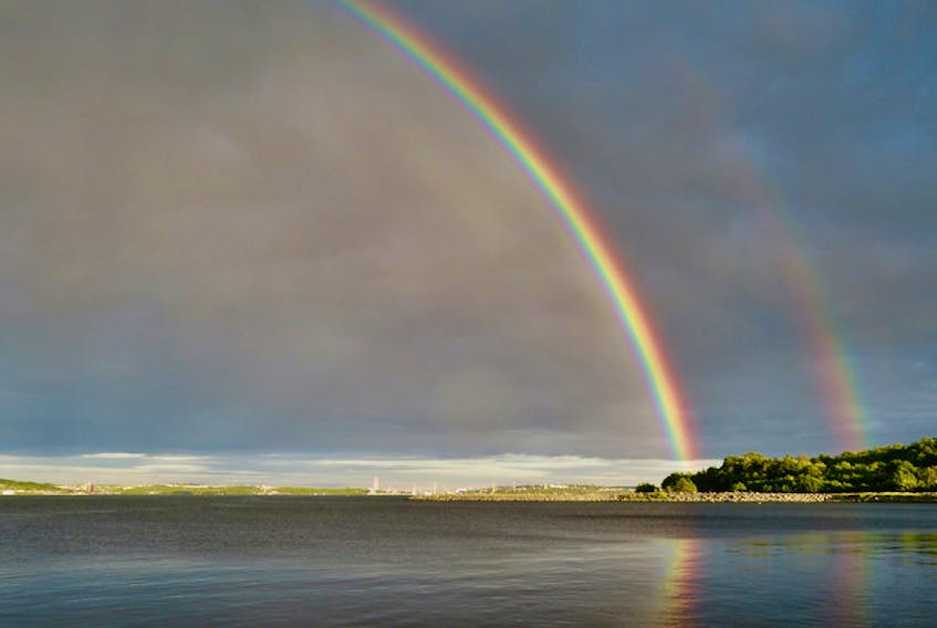 Sunday’s weather was unsettled – at times sunny, at times quite stormy.  The showers and thundershowers served up a few lovely double rainbows across the region.  Jean Johnston captured this stunning photo over the Bedford Basin in Halifax.  She says it was so vivid that “all the people strolling the walkway were awed as it lasted a long time”. 
Jean observed that even after the rainbows has faded the clouds were beautiful over the bridges.
Quite a show indeed!