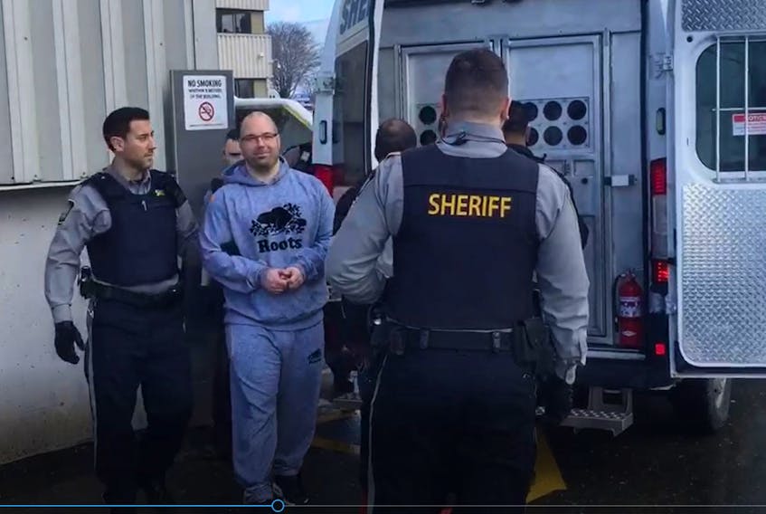 Brian James (B.J.) Marriott is led to a sheriff’s van after appearing in Dartmouth provincial court in February 2020 on six charges, including attempted murder and conspiracy to commit murder.