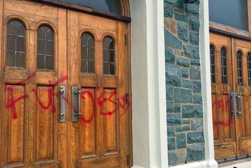 The main doors at St. Agnes Catholic church on Mumford Road in Halifax were defaced with offensive graffiti overnight Sunday. (John McPhee / The Chronicle Herald)