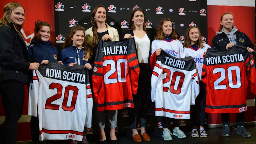 
Jill Saulnier and Blayre Turnbull, members of the Canadian women's hockey team, are surrounded by minor hockey players from the Halifax area at the Scotiabank Centre in Halifax for the announcement Tuesday morning that the 2020 IIHF women's world championship will be co-hosted by Halifax and Truro. - Francis Campbell
