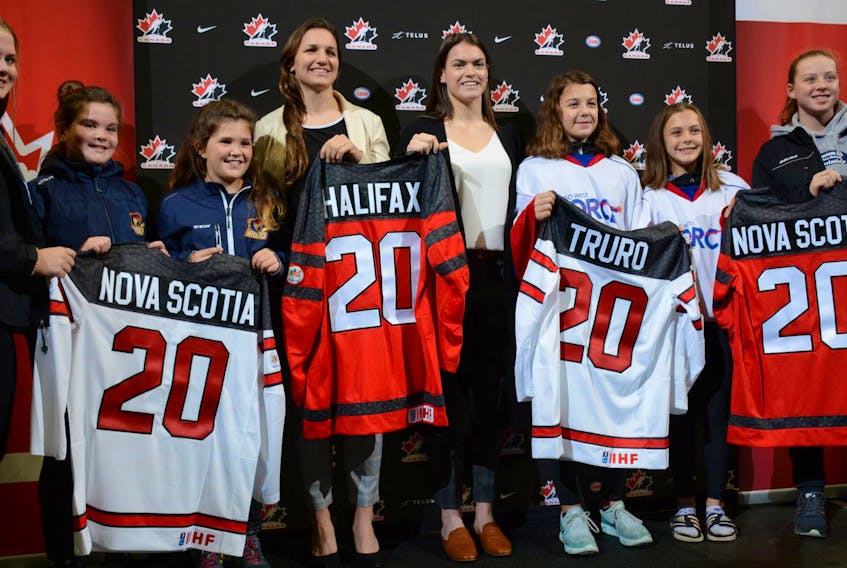 
Jill Saulnier and Blayre Turnbull, members of the Canadian women's hockey team, are surrounded by minor hockey players from the Halifax area at the Scotiabank Centre in Halifax for the announcement Tuesday morning that the 2020 IIHF women's world championship will be co-hosted by Halifax and Truro. - Francis Campbell
