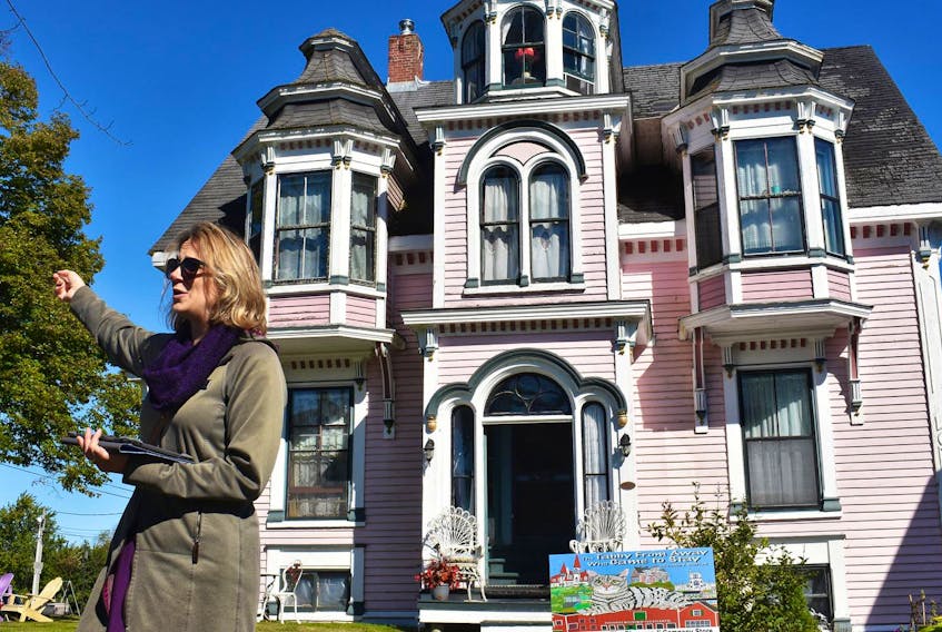 
Guide and co-owner of Lunenburg Walking Tours, Ashlee Feener, stands in front of author James Bradford’s house in Lunenburg, the location of his children’s book The Tabby From Away Who Came To Stay. Bradford’s cat can often be spotted in the window. (Josh Healey)
