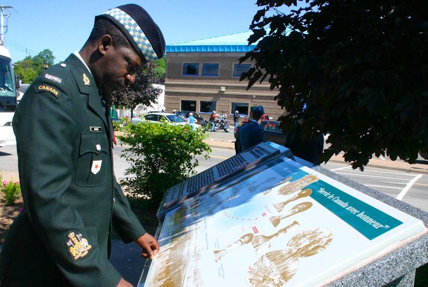 
Chief Warrant Officer Kevin Junor checks the monument sitting on Pictou’s waterfront that is dedicated to the memory of the No. 2 Construction Battalion of the Canadian Expeditionary Force, Canada’s first and only all-black battalion, in 2008. - Herald file 
